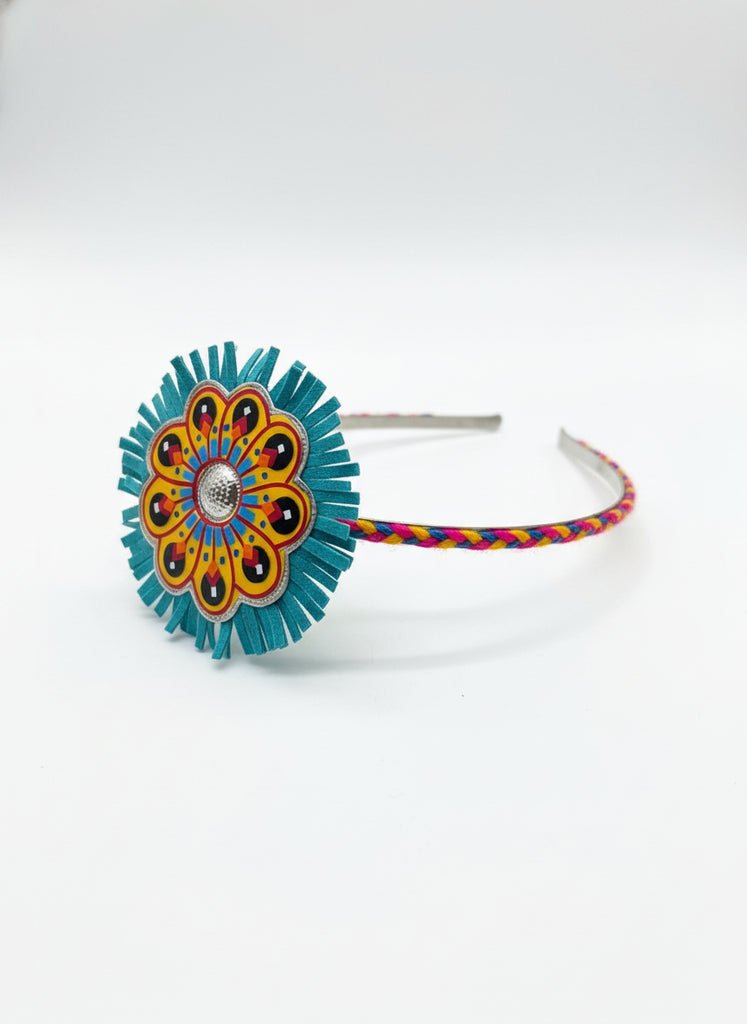 Decorative headband with colorful flower design on a wooden surface