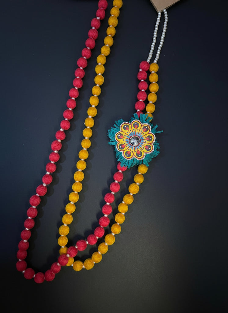 Colorful beaded necklace with a decorative clasp on a wooden surface
