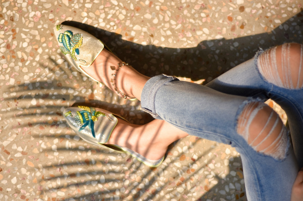 Neon thread colored embroidered motif on pointed glittery mule 